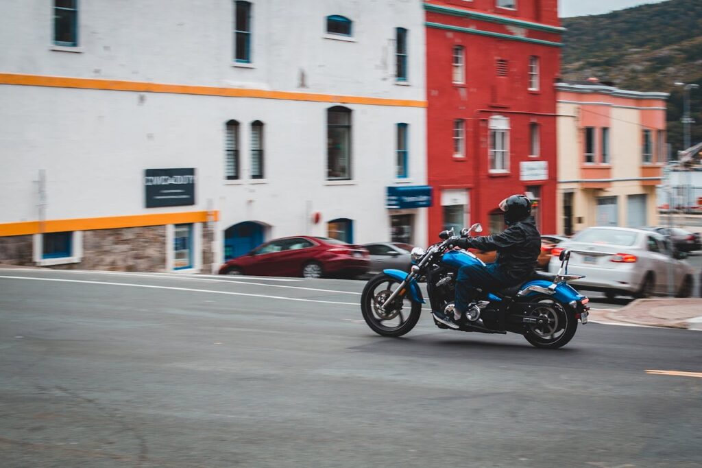 Anonymous man driving motorcycle on road
